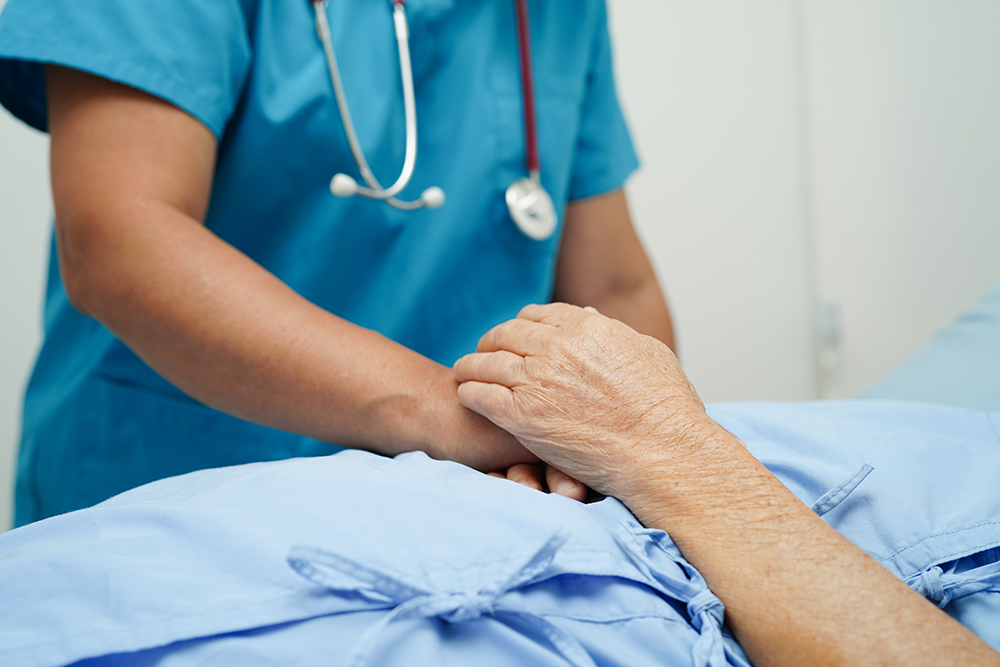 Doctor holding hands Asian elderly woman patient, help and care in hospital.