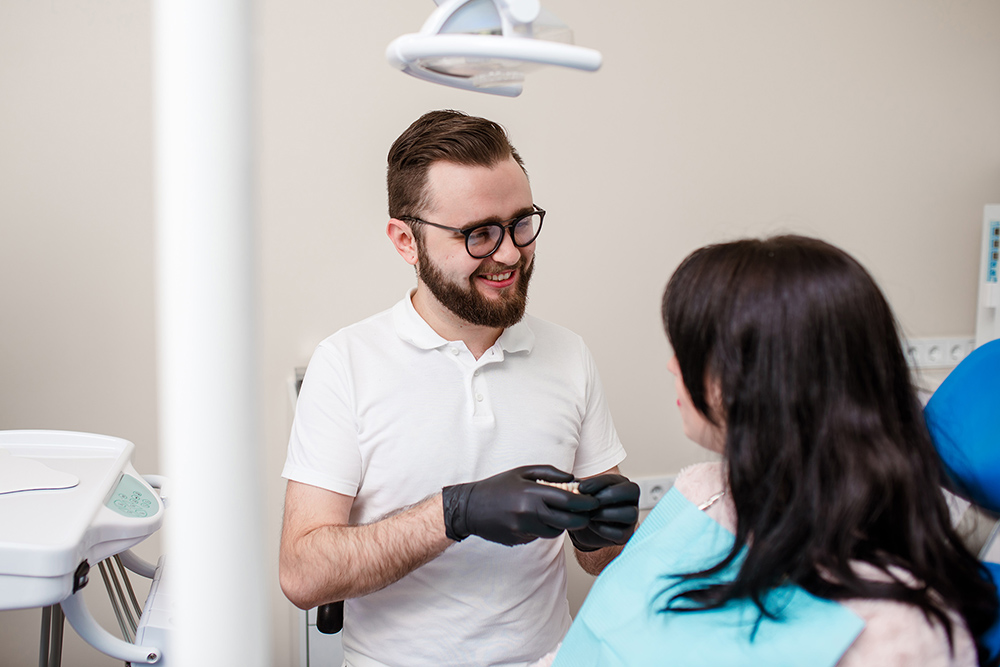 Dentist doing a dental treatment on a female patient