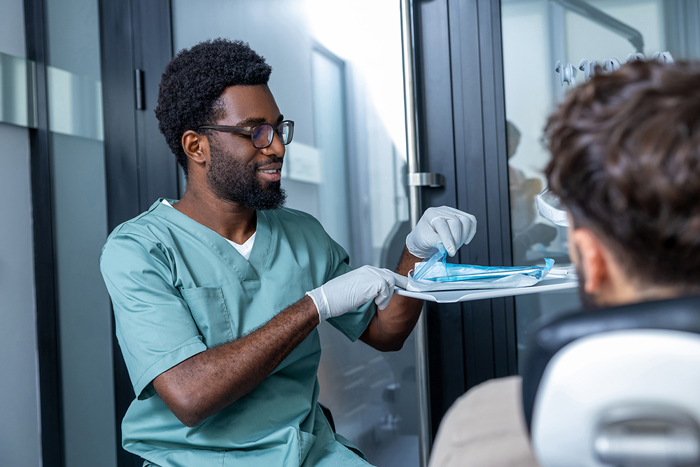 Man sitting in dentist chair during oral checkup i n modern clinic