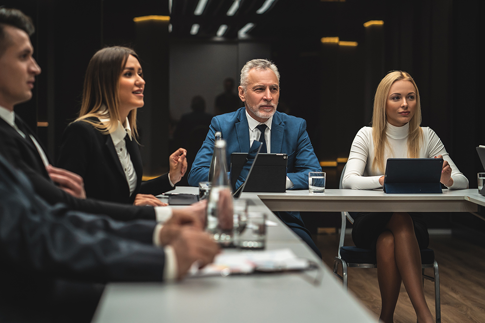 The people sitting at the table on business conference