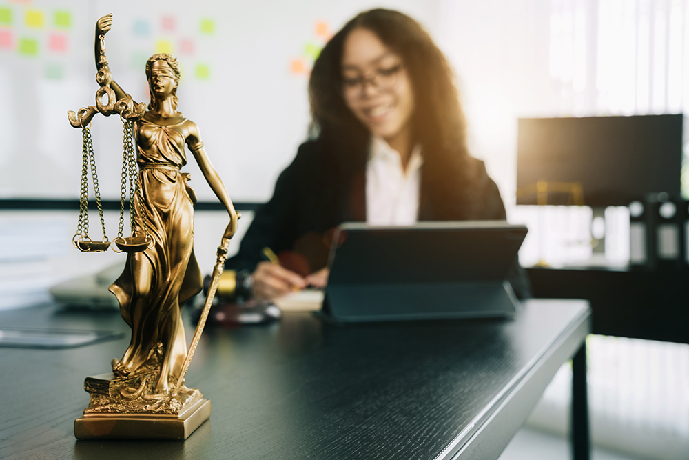 statue of justice with scales and auction hammer,  the law firm behind the concept of in office law.